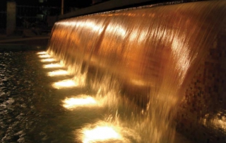 illuminated-waterfall-fountain Adding lights to a waterfall fountain can help it please guests no matter the outside lighting